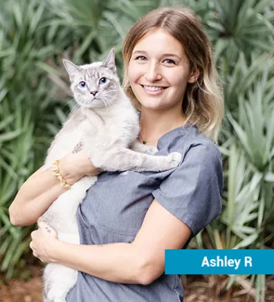 Staff member with white cat